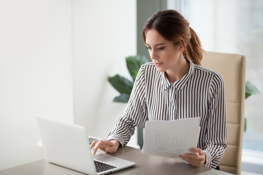 Woman working on a veterinary real estate and practice valuation.